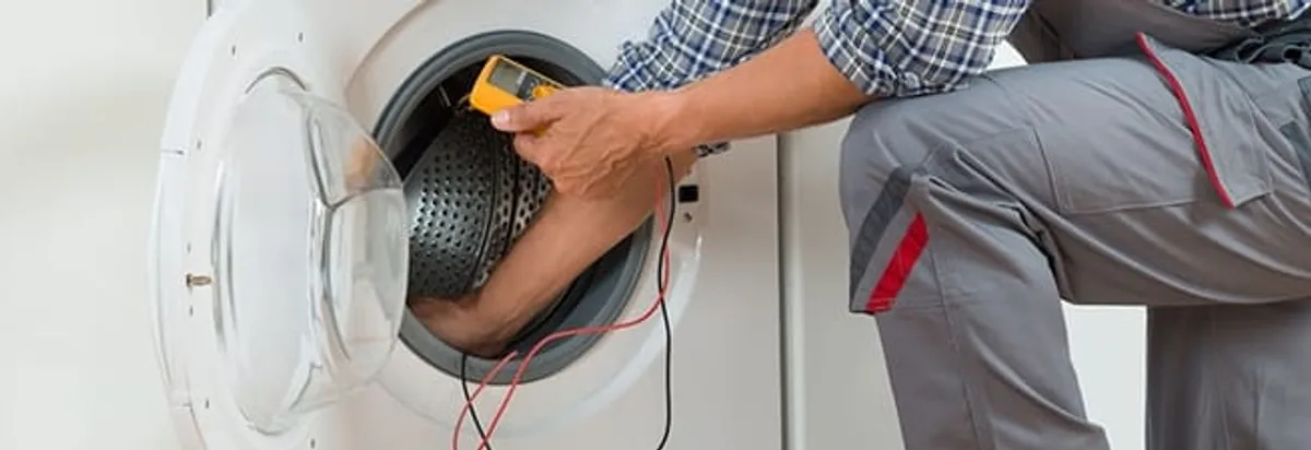 Dryer repair technician inspecting and repairing a clothes dryer in Miami, FL